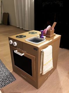 an oven made out of cardboard sitting on the floor