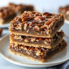 three pieces of pecan bar stacked on top of each other