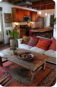 a living room filled with furniture and lots of pillows