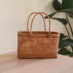 The Bali Woven Rattan Handbag is the perfect accessory for any stylish woman. This beautiful handmade rattan bag is crafted by skilled artisans in Bali, using natural materials to create a unique and practical piece. The woven design adds a unique texture to the classic rattan style, making it the perfect handbag for everyday or evening outings. The Bali Rattan Handbag features a spacious interior and exquisite design that is sure to leave a lasting impression. Add a touch of Bali's charm to you Rattan Style, Rattan Handbags, Fashion Movement, Stocking Stuffers For Men, Woven Handbags, Perfect Handbag, Astrology Gift, Rattan Bag, Net Bag