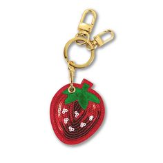 a red strawberry shaped keychain hanging from a gold metal hook on a white background