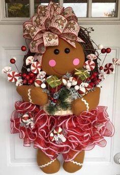 a gingerbread christmas door hanger with candy canes