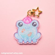 a blue frog with a pink crown on it's head sitting next to a star