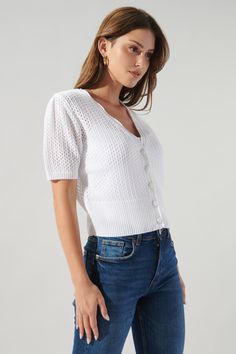 Coast to coast. This cute little cardi is the perfect cover up for those cool mornings and brisk evenings. It features a functional button front with a scalloped edge. A ribbed sweep balances off the top, making it ideal for layering over tanks and pairing with cutoffs or cropped wide leg denim.- Crochet knit- Button front- Scallop edge- Ribbed sweep- Comes in 2 colorsSize + Fit - Model is 5'8" and wearing size XS- Measurements taken from size S - Chest: 34"- Length: 19" Fabric Self: 100% Cotton Denim Crochet, Sleeve Crochet, Scallop Edge, Coast To Coast, White Cardigan, Feminine Look, Unique Designers, Wide Leg Denim, Scalloped Edge