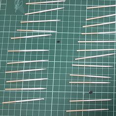 several toothpicks are arranged on a cutting board