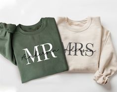 two sweatshirts with the letters mr and mrs printed on them, one in green and one in white