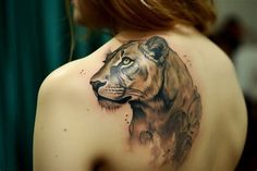 a woman with a tiger tattoo on her back