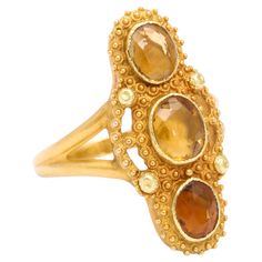 Three oval topaz gems are vertically set in 18 Kt Gold in this Georgian ring. The gems look as if drops of honey spiked into place on this three stone setting. Superb gold work stands out in the smallest spirals of cannetille work and the minute gold bead granulation. A luscious medium sized ring that can be sized and will call to your eye throughout the day. c. 1830. French Origin and hallmarked. Excellent Condition. Size 6 3/4 to 7. It is sizable. Rose Gold Chandelier Earrings, Georgian Ring, Rings Luxury, Gold Chandelier Earrings, Vintage Fine Jewelry, Diamond Cocktail Rings, Expensive Jewelry, Gold Work, Citrine Ring