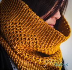 a woman wearing a yellow knitted scarf