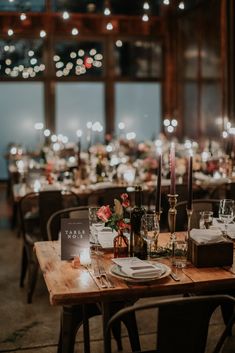 a table set up with place settings and candles