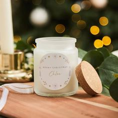 a white candle sitting on top of a wooden table