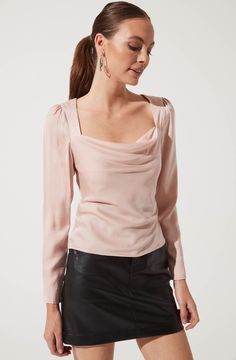 A dressy top for any occasion. It features a flattering cowl neck that descends to a fitted bodice and features a statement cutout back. Long sleeves. Smocked back. Abaya Design, Modest Tops, Cutout Top, Evening Tops, Astr The Label, Chic Shop, Cowl Neck Top, Cut Out Top, Stylish Dresses For Girls