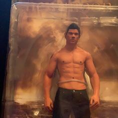 a man with no shirt is standing in front of a plastic box holding his hands on his hips