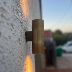 a wall mounted light on the side of a building