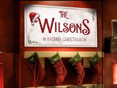 christmas stockings hanging from hooks in front of a sign that reads, the wilsons is merry christmas