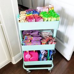 a cart filled with lots of candy on top of a hard wood floor