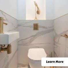 a white toilet sitting next to a sink in a bathroom under a faucet