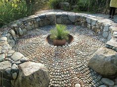 a circular rock garden with a potted plant in the center