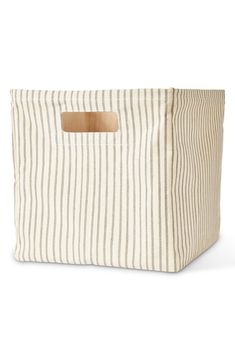 a striped storage bag with a wooden handle