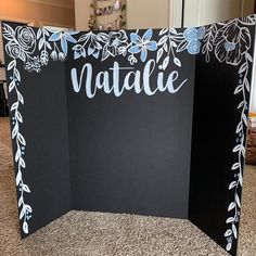 a black and white photo frame with the word natalie painted on it's side