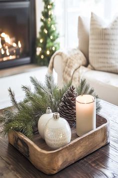 Festive farmhouse Christmas coffee table decor with candles, red ornaments, and greenery. Christmas Decor Coffee Table, Christmas Coffee Table, Christmas Coffee Table Decor, Farmhouse Christmas Decor Ideas, Boho Farmhouse Decor, Boho Christmas Decor, Neutral Christmas Decor, Coffee Table Decor, Christmas Porch Decor