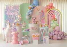 a room filled with lots of balloons and unicorns next to a table full of cakes