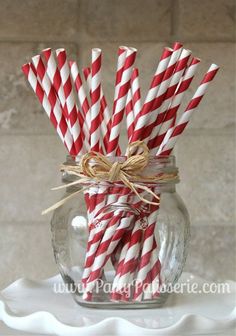 red and white striped straws in a mason jar