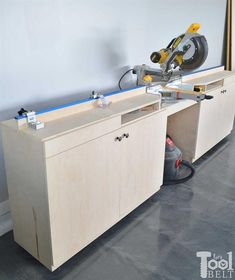 a workbench with a circular saw on it and tools in the cabinet doors