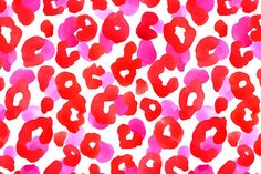 red and pink watercolor spots on white paper