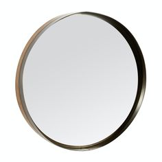 a round mirror on a white wall with a black frame and gold trim around the edges