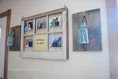 an old window is hung on the wall next to two mason jars filled with photos