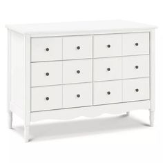 a white dresser with many drawers on it