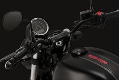 the handlebars and gauges are visible on this motorcycle's black background