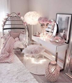 a bedroom with white fur and pink decorations on the bed, mirror, lamp, vases and birdcage