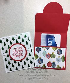 an open envelope with christmas cards inside and on the front, next to it is a card that says merry bright