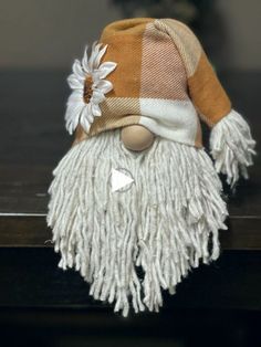 a close up of a stuffed animal with a hat on it's head and a flower in its hair