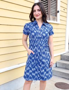 You'll feel regal in our Majestic Cotton Button Dress. Designed in royal blue ikat fabric, this dress boasts a refined collar, a flattering tie waist, and charming gathering at the sleeves. The front buttons add a classic touch, making it the perfect choice for a sophisticated and timeless look that stands out in any setting. Easy-to-open cotton button dress that is great for nursing or pumping mothers. FIT Model is 5'3" and wears S True to size. If in between sizes, size up This fabric does not Fitted Collared Shirt Dress With Tie Waist, Blue Belted Button-up Dress, Casual Blue Dress With Collared Neckline, Fitted Cotton Shirt Dress With Tie Waist, Blue Fitted Belted Dress With Short Sleeves, Classic Collared Dresses With Tie Waist, Classic Collared Dress With Tie Waist, Fitted Collared Dress With Tie Waist, Blue Collared Belted Dress