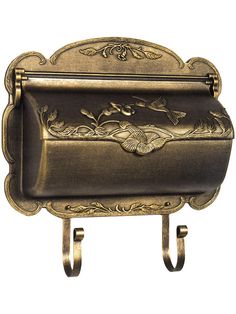 an ornately decorated metal mailbox on a stand