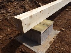 a wooden bench sitting on top of a dirt field