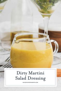 dirty martini salad dressing in a glass pitcher with the words dirty martini salad dressing above it