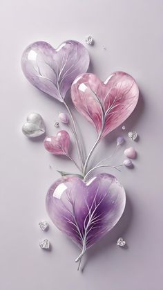 three heart shaped balloons with leaves and diamonds on the bottom one is pink, purple and white