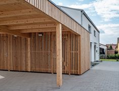 an outdoor covered area with wooden slatted walls