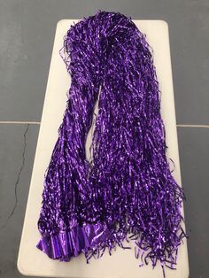 a purple scarf is laying on a white tray and it looks like something out of space