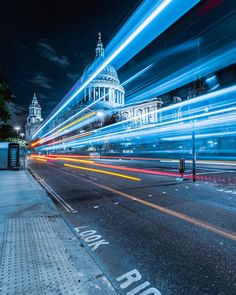 long exposure shot of the capital building in london at night with lights streaking by