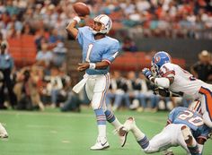 a football player throwing a ball during a game with other players in the stands watching