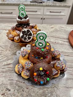 two trays filled with donuts covered in chocolate frosting and sprinkles