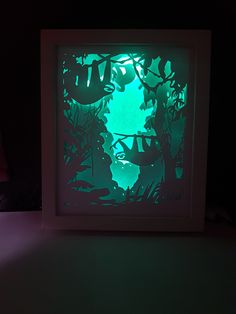 the shadow of leaves is projected in an illuminated frame