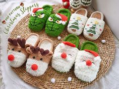 several knitted christmas slippers are on a wicker tray next to other holiday decorations