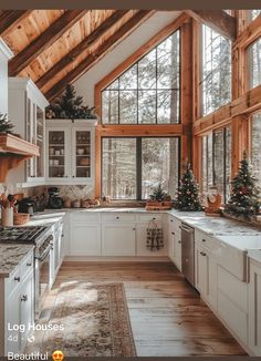 a kitchen with white cabinets and wooden beams on the ceiling is decorated for christmas time