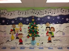 a christmas bulletin board in an office cubicle decorated with musical notes and cartoon characters